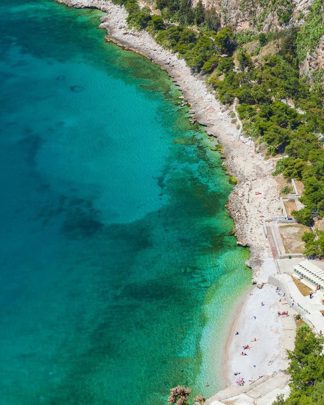 Aerial view of a turquoise pebble beach on the coast near Nafplio