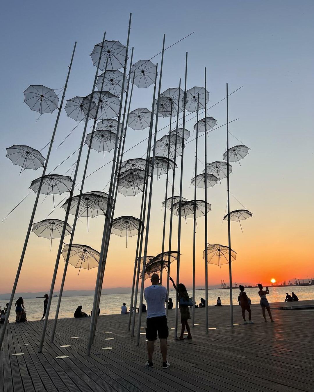 The Umbrellas sculpture on the Thessaloniki waterfront at sunset