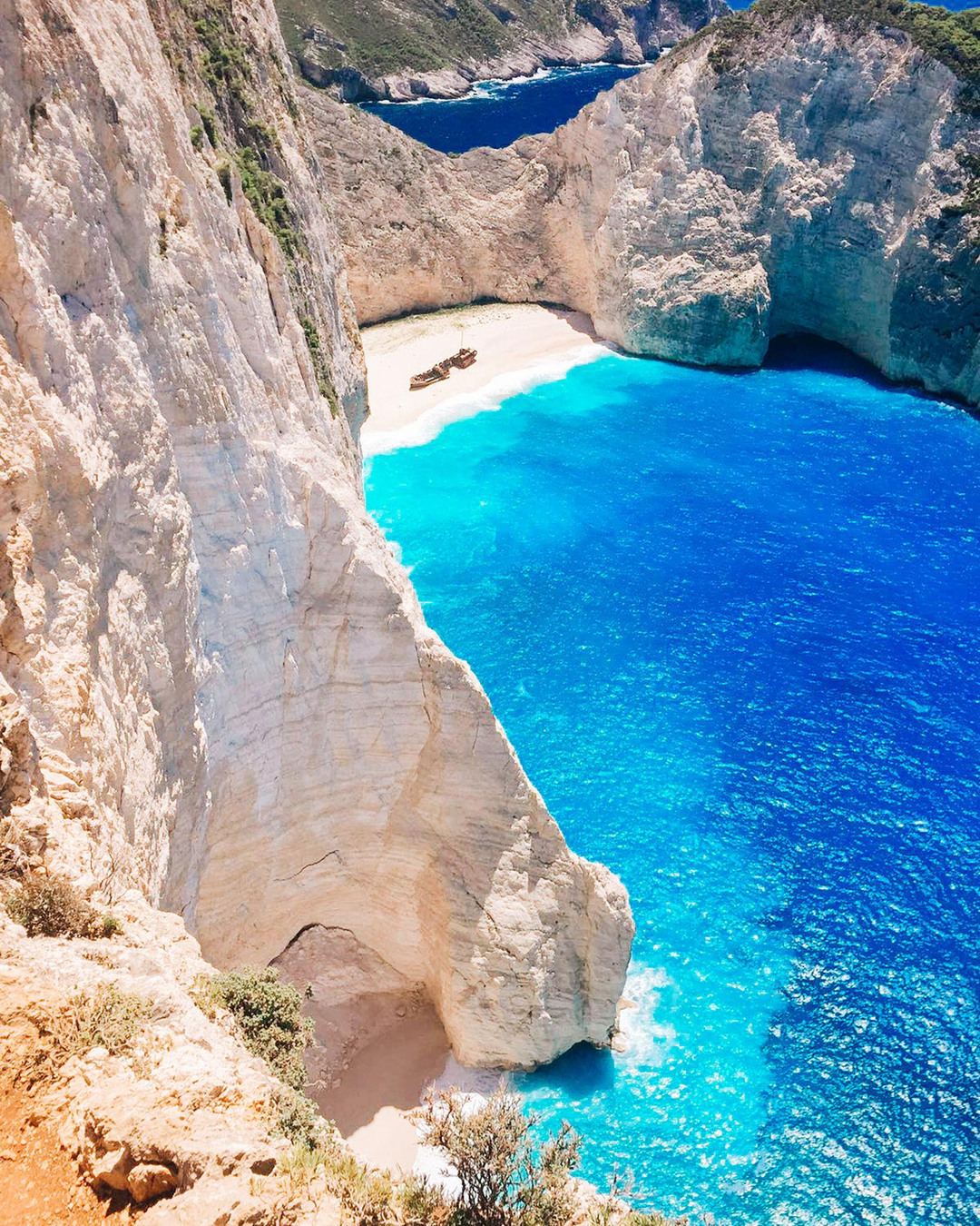 Navagio bay and its white cliffs seen from the clifftop viewpoint on Zante