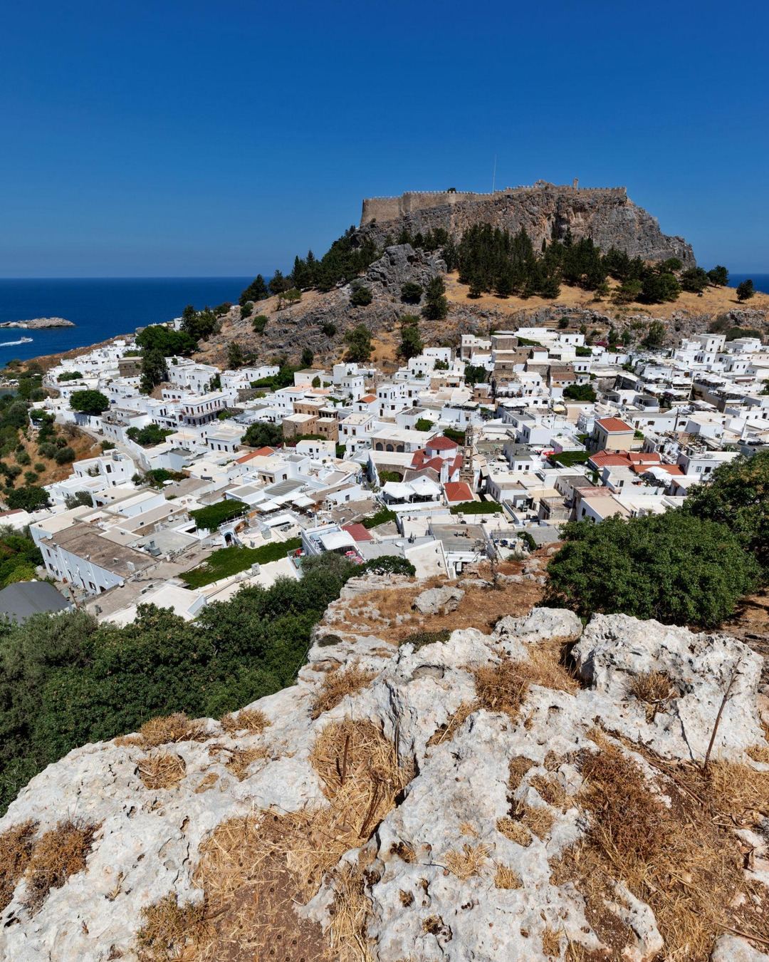 The whitewashed village of Lindos beneath its ancient acropolis on Rhodes