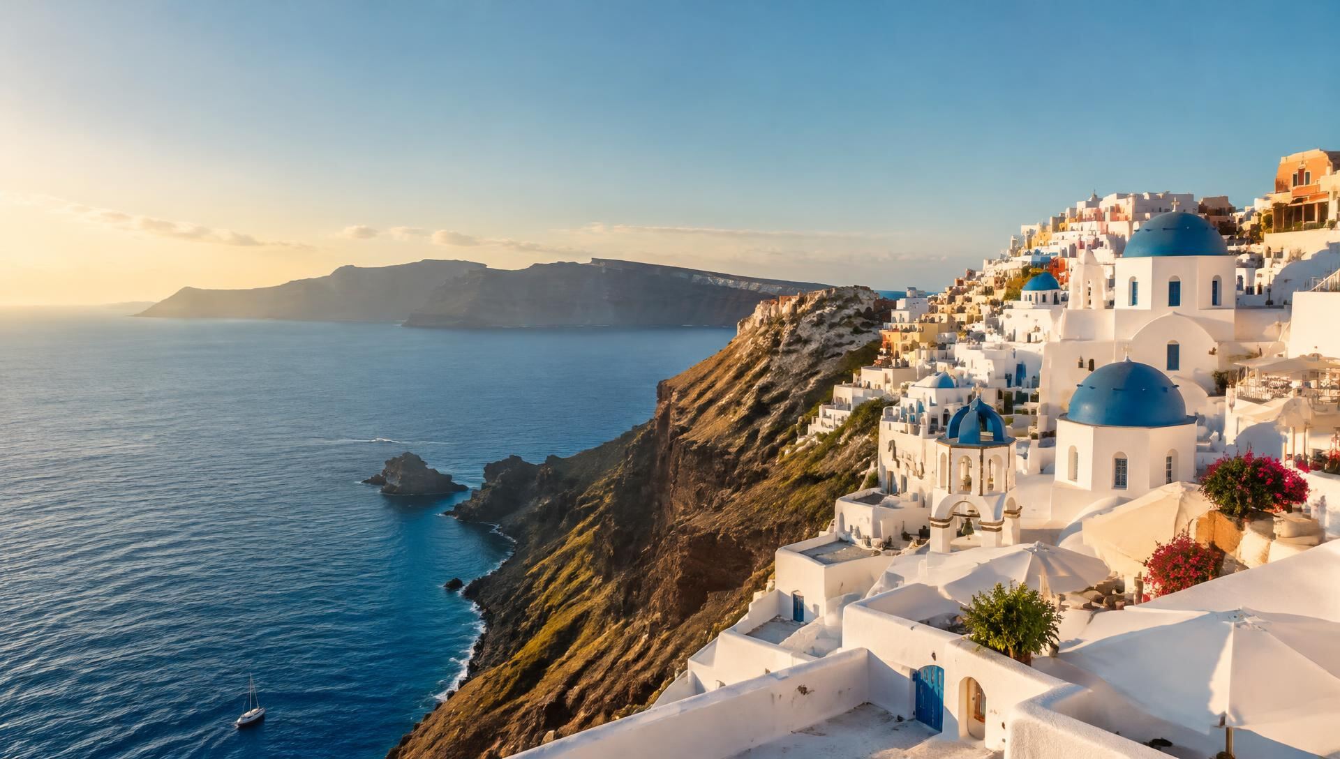 Whitewashed village and blue domes above the Aegean Sea at golden hour